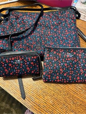 Coach Black Floral crossbody with 2 accessory pieces.